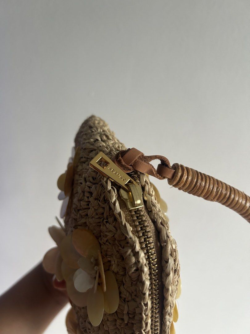 Mona Shell Handbag (Category: Beach Bags) located in Manila. Submitted by clasicamnl (Listing ID 1467451404, Image 3). Description: Comes with dust bag This charming handbag is crafted from natural raffia and features a rattan-wrapped handle and delicate floral shell embellishments. .