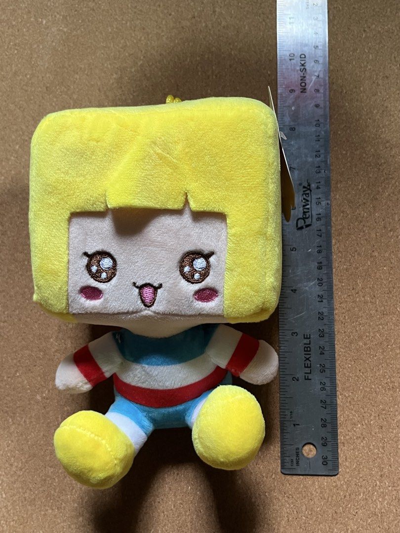 Mr. Box Plush (Category: Plushies & Soft Toys) located in Baguio. Submitted by gaara1234 (Listing ID 1467449700, Image 1). Description: - Adorable yellow cube-head plush toy with big sparkling brown eyes - Stands/sits at approximately 7 inches tall - Features a playful design with a pink tongue sticking out - Dressed in a cute blue, white, and red striped outfit with matching yellow shoes - Super soft and huggable texture - Perfect for gifts or c