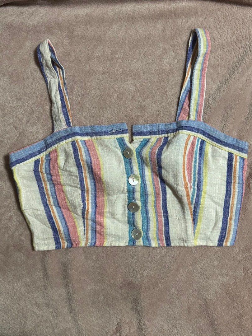 Multicolor Striped Button-Front Crop Top (Category: Blouses) located in Quezon City. Submitted by ky_aly_ (Listing ID 1467493202, Image 1). Description: - Style: Multi-colored striped crop top with thin straps and straight hem - Details: Front button closure with four round white buttons - Material: Light linen texture fabric - Colors: Blue, pink, yellow, and navy horizontal stripes.
