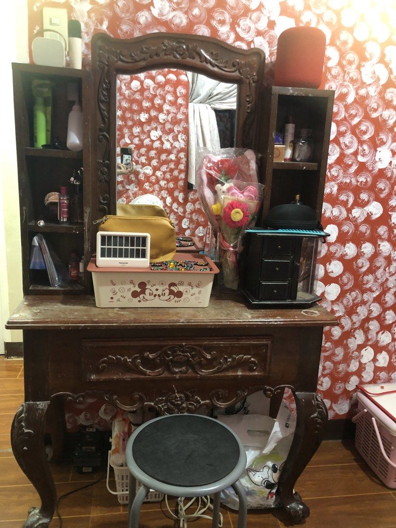 Narra vanity table (Category: Tables & Sets) located in Cavite. Submitted by ai__chang (Listing ID 1467452987, Image 1). Description: - Upper part is removable - Solid wooden dressing table featuring classic carved floral details - Large attached mirror for daily grooming and makeup - Ample storage with side shelves, upper compartments, and a front drawer - Includes a matching stool with a comfortable cushioned round seat.