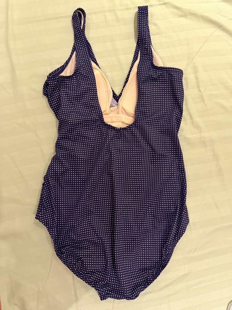 Navy Blue Polka Dot One Piece Swimsuit (Category: Bikinis & Swimsuits) located in Quezon City. Submitted by caathhx_ (Listing ID 1467510281, Image 2). Description: - Navy blue one-piece swimsuit with cute white polka dots - Flattering V-neckline with a wrapped front design and side ruching - Built-in light beige soft bra cups for comfortable support - Secure wide shoulder straps and classic high-cut legs - Chic scoop back style, ideal for beach t