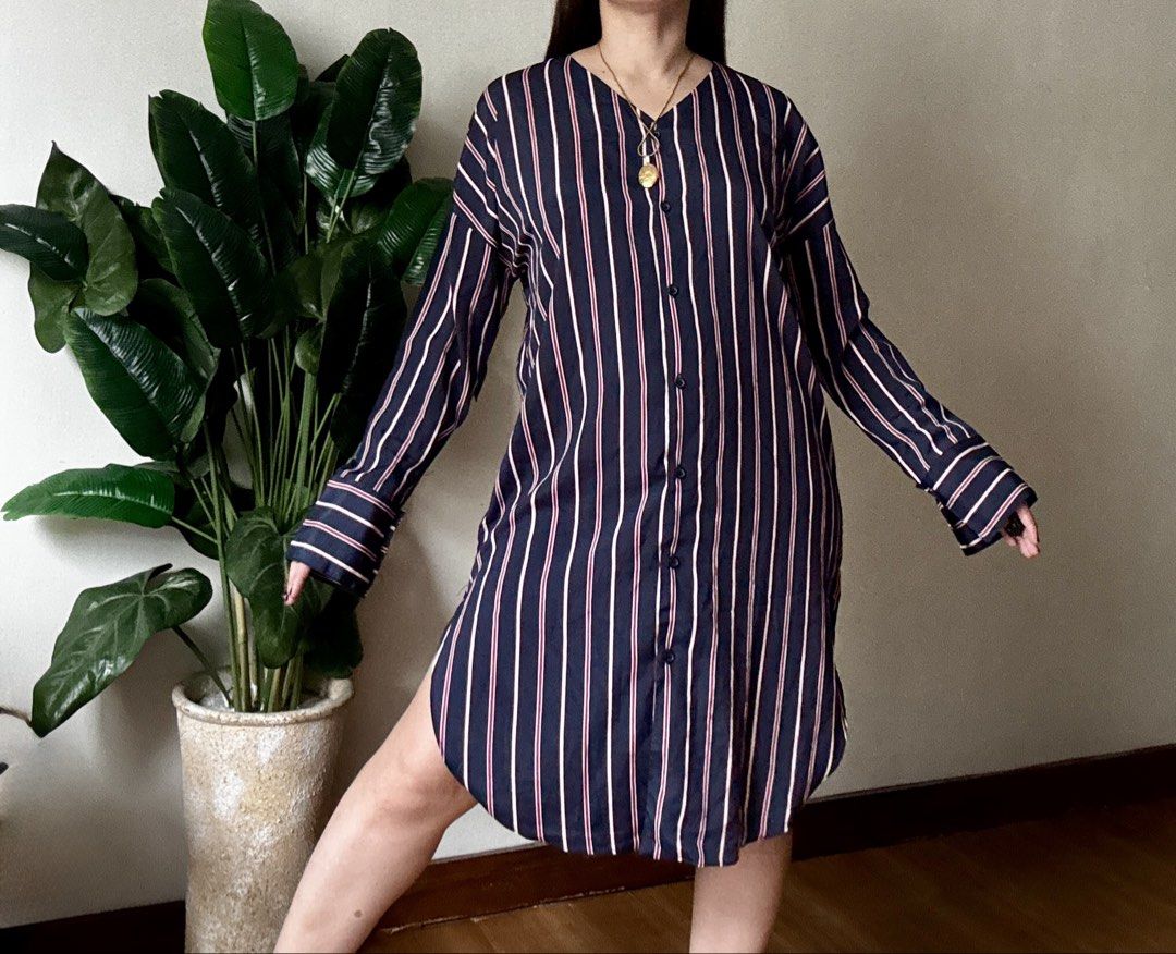 Navy Blue Striped Button-Down Dress,m to l (Category: Dresses) located in Mandaluyong City. Submitted by roxieeeeeee (Listing ID 1467519830, Image 1). Description: - Color & Pattern: Navy blue with vertical white and pink stripes - Design: Button-down front closure with matching buttons and a flattering V-neckline - Sleeves: Long sleeves with stylish wide cuffs - Fit & Length: Midi length featuring high side slits on both sides and a curved hemli
