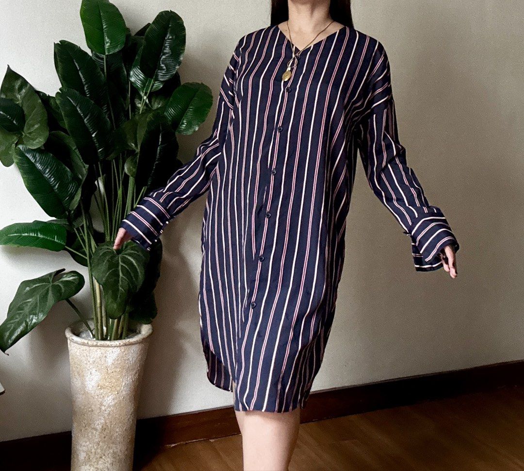 Navy Blue Striped Button-Down Dress,m to l (Category: Dresses) located in Mandaluyong City. Submitted by roxieeeeeee (Listing ID 1467519830, Image 3). Description: - Color & Pattern: Navy blue with vertical white and pink stripes - Design: Button-down front closure with matching buttons and a flattering V-neckline - Sleeves: Long sleeves with stylish wide cuffs - Fit & Length: Midi length featuring high side slits on both sides and a curved hemli