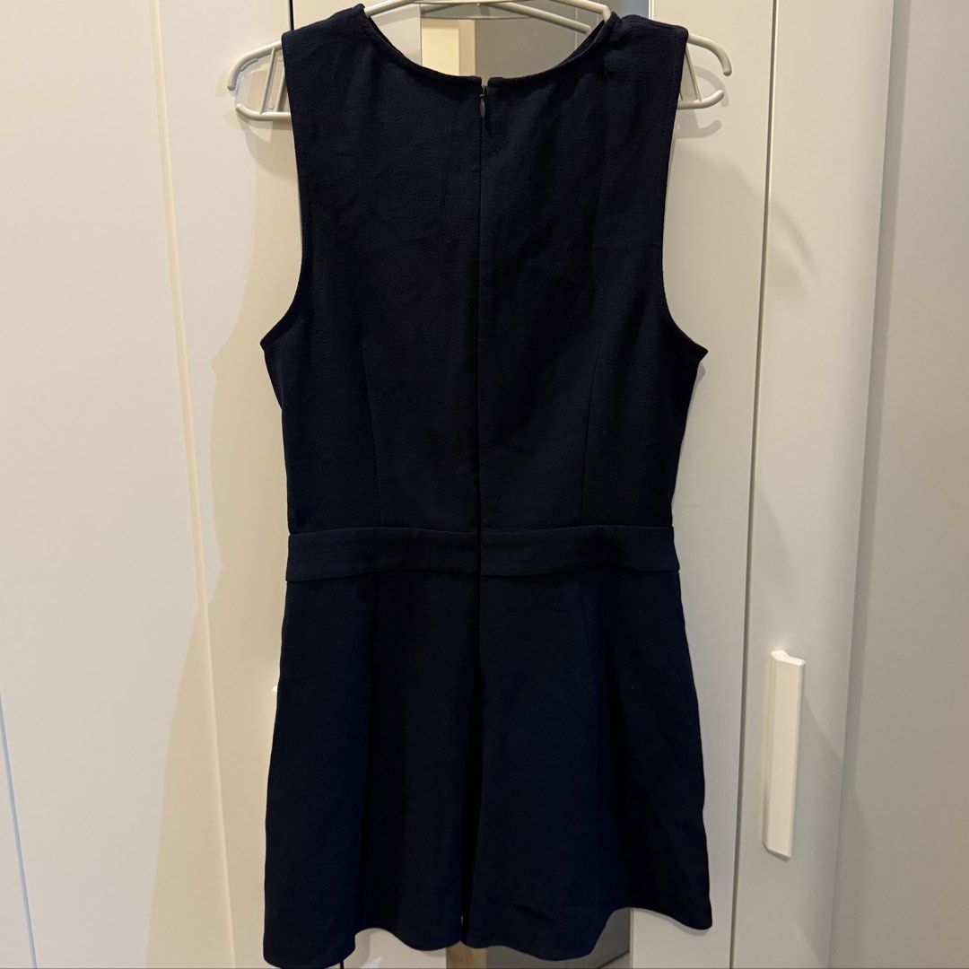 Navy Blue Twist Front Romper (Category: Rompers) located in Marikina City. Submitted by lovegoeson (Listing ID 1467533632, Image 2). Description: - Color: Dark navy blue - Style: Sleeveless romper with front twist bodice, fitted waist, and flared shorts - Closure: Back zipper near the neckline - Material: Textured fabric - Condition: Clean and well-maintained - Best for: Casual outings and weekend wear.