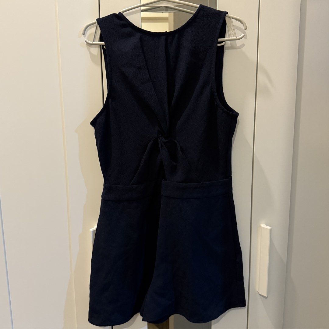Navy Blue Twist Front Romper (Category: Rompers) located in Marikina City. Submitted by lovegoeson (Listing ID 1467533632, Image 1). Description: - Color: Dark navy blue - Style: Sleeveless romper with front twist bodice, fitted waist, and flared shorts - Closure: Back zipper near the neckline - Material: Textured fabric - Condition: Clean and well-maintained - Best for: Casual outings and weekend wear.