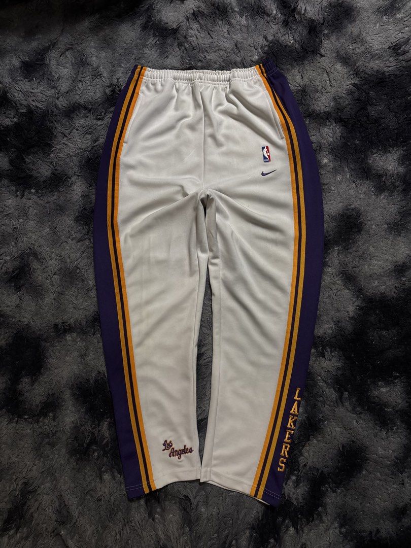 NBA LAKERS 90'S WARMERS (Category: Joggers) located in Manila. Submitted by aeronmaurcio (Listing ID 1467417732, Image 1). Description: NBA LAKERS 90'S WARMERS VINTAGE PIECE LIKE NEW HAS BUTTONS NEAR LEG OPENING W- 27 TO 40 THIGH- 12.5 L- 42.5 LEG OPENING- 7.5.