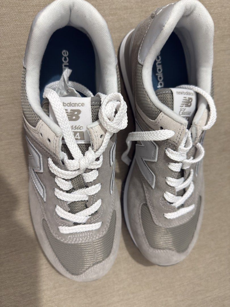 New Balance 574 Classic Grey Sneakers (Category: Sneakers) located in Manila. Submitted by lucky_anton (Listing ID 1467530384, Image 1). Description: Grey and white New Balance 574 classic sneakers. Suede and mesh upper with white laces. ENCAP midsole cushioning for comfort. Iconic N logo on the sides. Clean soles and crisp white interiors. Great everyday pair with timeless design..
