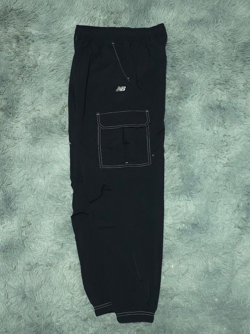 New Balance Black Cargo Pants (Category: Joggers) located in Abulug. Submitted by humanwhosellthings (Listing ID 1467404119, Image 2). Description: - Brand: New Balance ✅Excellent Condition ✅Issue: none ▫️Waist Size: 24-36 ▫️Length: 37 - Color: Black with contrast white stitching - Features: Elastic waistband, side pockets, and utility pockets on both legs - Branding: Small embroidered NB logo near the right hip - Fit: Relaxed fit with cuffed hem