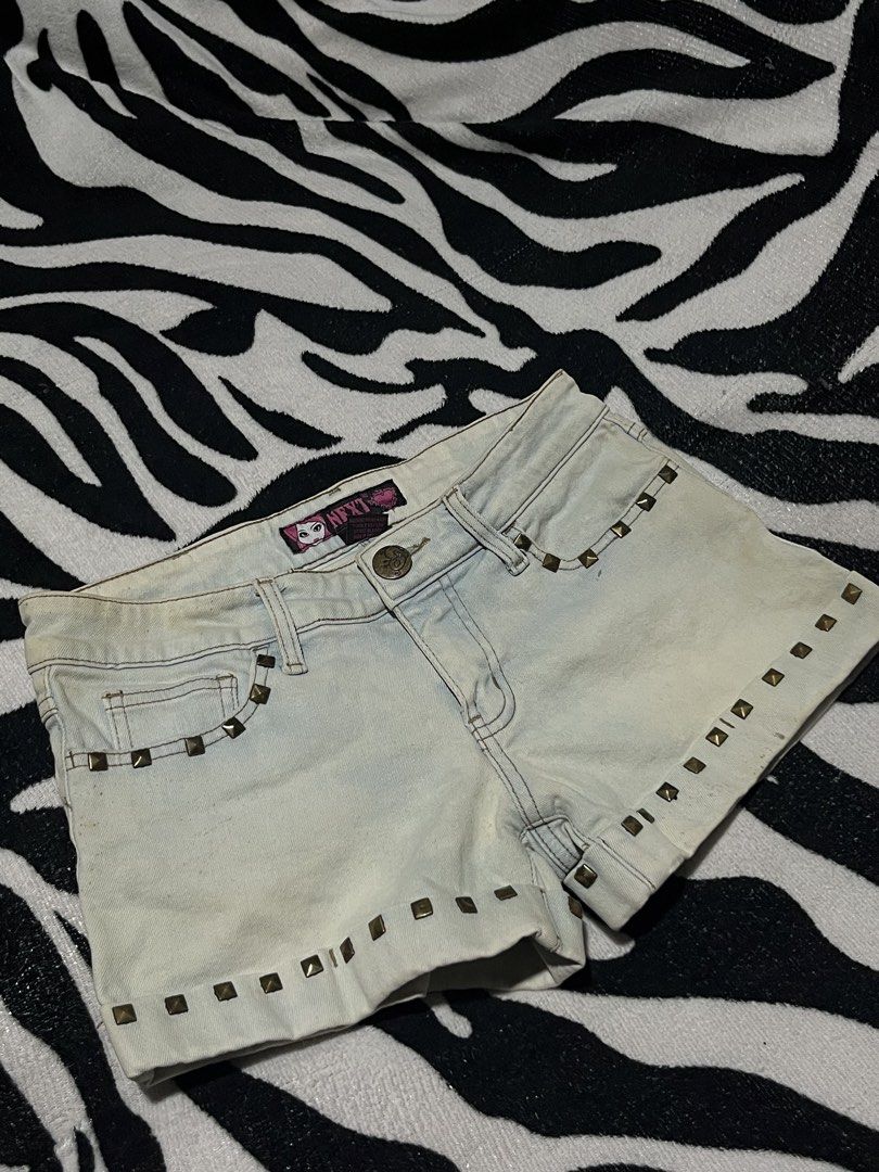 Next denim shorts studded y2k grunge medium size (Category: Shorts) located in Manila. Submitted by y2kcloset_ (Listing ID 1467476424, Image 2). Description: - Brand: Next - Size: Medium - Color: Light wash blue - Details: Studded front pockets and hem, branded waistband tag - Closure: Button and zipper fly - Style: Vintage 2000s / Grunge aesthetic.