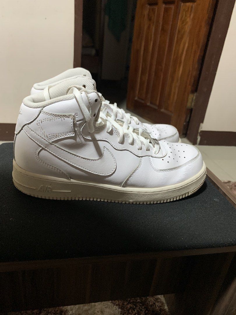 Nike Air Force 1 Mid White Sneakers (Category: Sneakers) located in Manila. Submitted by rain_dreams (Listing ID 1467469595, Image 3). Description: - Authentic Nike Air Force 1 Mids (All-White) - Iconic leather upper with toe box perforations - Comfortable Nike Air cushioning and metallic AF1 lace dubraes - Condition: Regular wear with minor toe box creasing and slight midsole yellowing - Soles: Still have plenty of life left - Laces: Clean and f