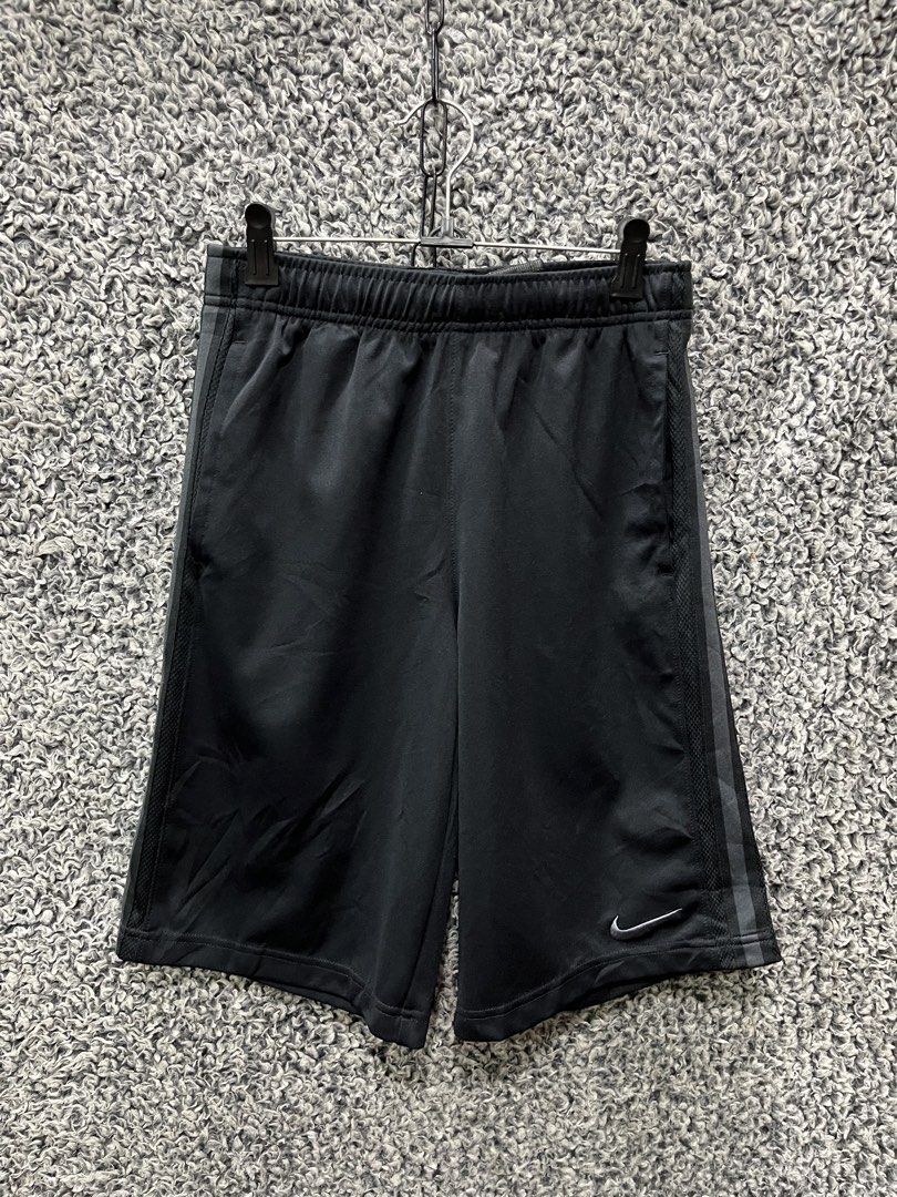 Nike athletic training shorts | Size L (Category: Shorts) located in General Trias. Submitted by zrchustle.604 (Listing ID 1467488649, Image 2). Description: Nike athletic training shorts featuring a vertical stripe down the side, an elastic drawstring waistband, and a grey or silver Nike Swoosh logo on the lower hem. • Brand: Nike • Color: Black with vertical side striping • Features: Breathable athletic fabric, drawstring waistband, side pocket