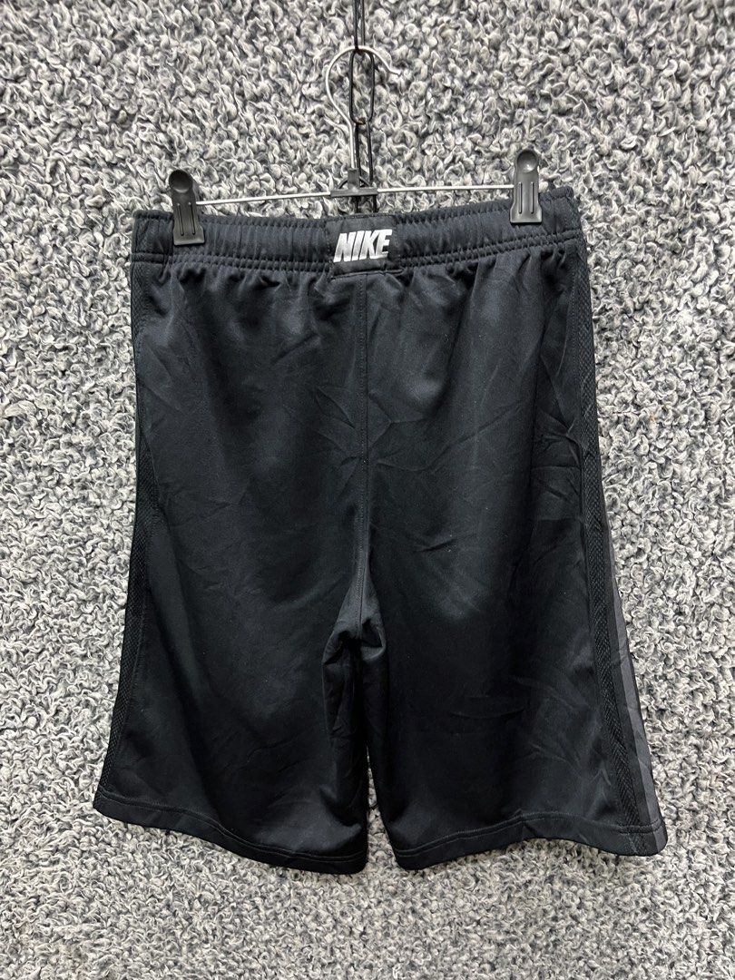 Nike athletic training shorts | Size L (Category: Shorts) located in General Trias. Submitted by zrchustle.604 (Listing ID 1467488649, Image 3). Description: Nike athletic training shorts featuring a vertical stripe down the side, an elastic drawstring waistband, and a grey or silver Nike Swoosh logo on the lower hem. • Brand: Nike • Color: Black with vertical side striping • Features: Breathable athletic fabric, drawstring waistband, side pocket