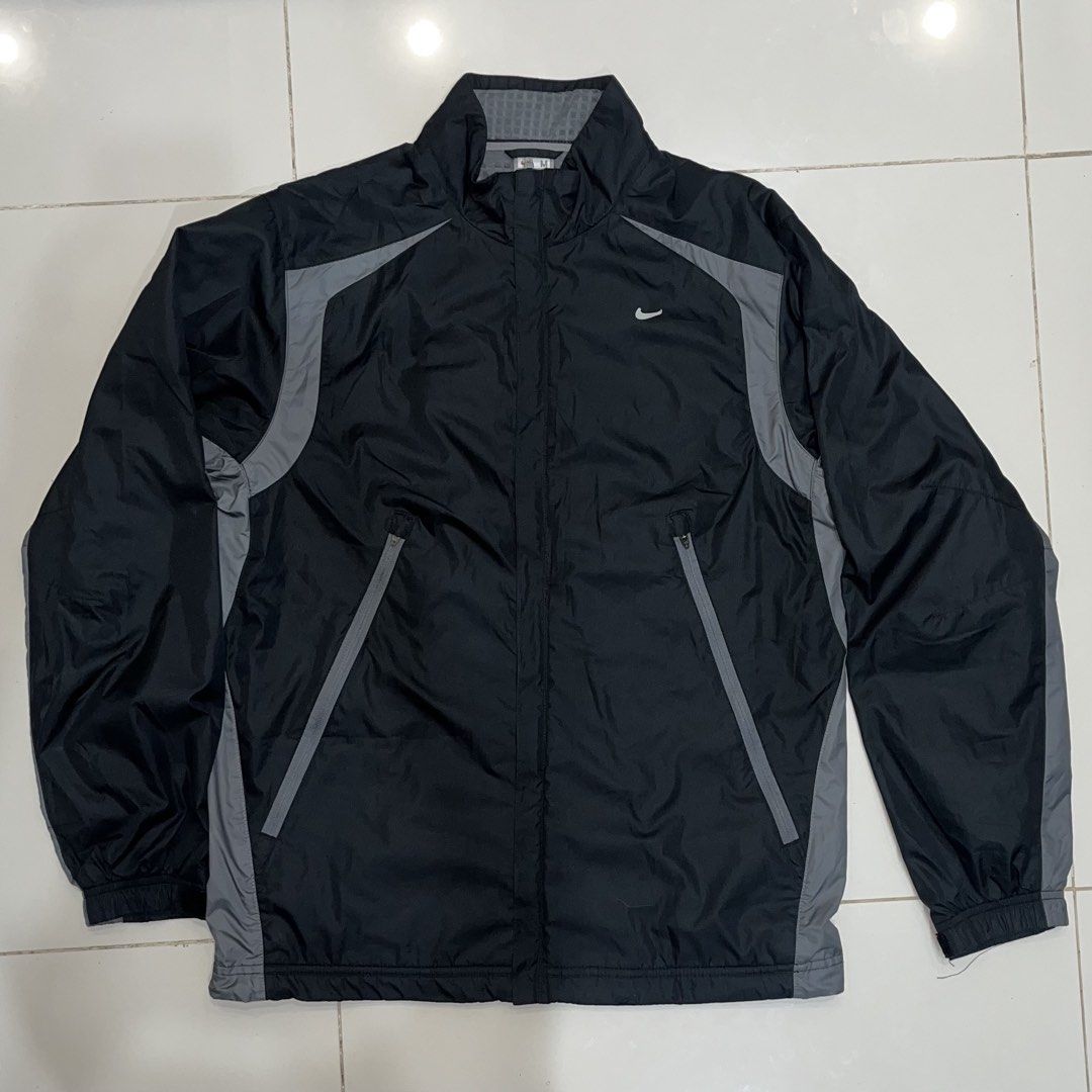 Nike Clima-FIT technical windbreaker track jacket (Category: Coats, Jackets and Outerwear) located in Puerto Princesa. Submitted by sydneyavouz (Listing ID 1467514084, Image 1). Description: - Brand: Nike - Color: Black with grey accent panels - Size: Medium (tag inside collar) - Features: Zip-up closure, high collar with textured grey lining, and zippered front pockets - Branding: White Nike swoosh logo on the right chest - Condition: Excellent,