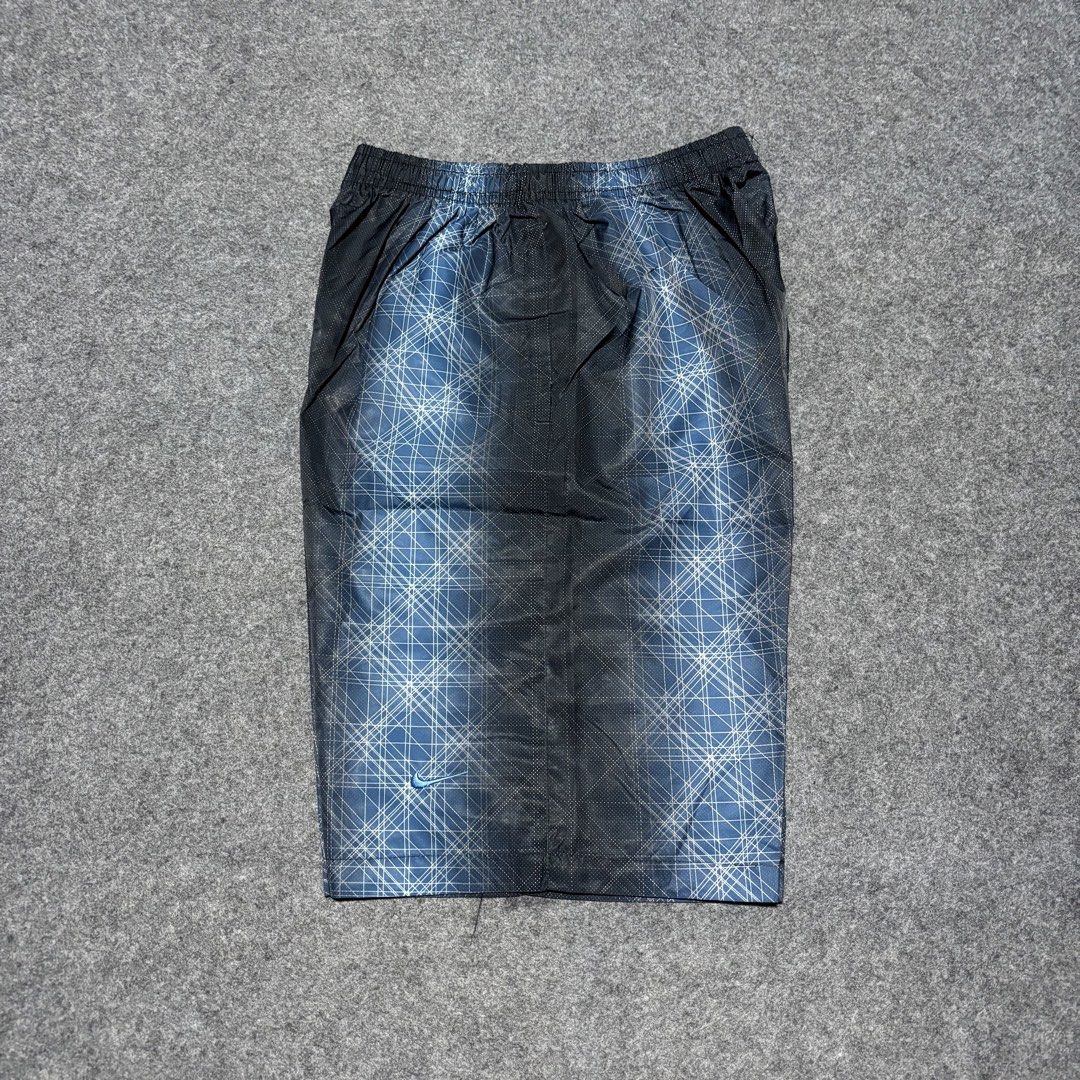 Nike Geometric Print Athletic Shorts (Category: Shorts) located in Cebu City. Submitted by andrewvivar29 (Listing ID 1467443984, Image 3). Description: - Brand: Nike - Color: Black and blue with geometric side pattern - Fit: Comfortable elastic waistband - Storage: Convenient back pocket with Nike Fit tag - Material: Lightweight, breathable mesh-like fabric - Style: Ideal for workouts, gym sessions, or casual streetwear - Condition: Excellent / R