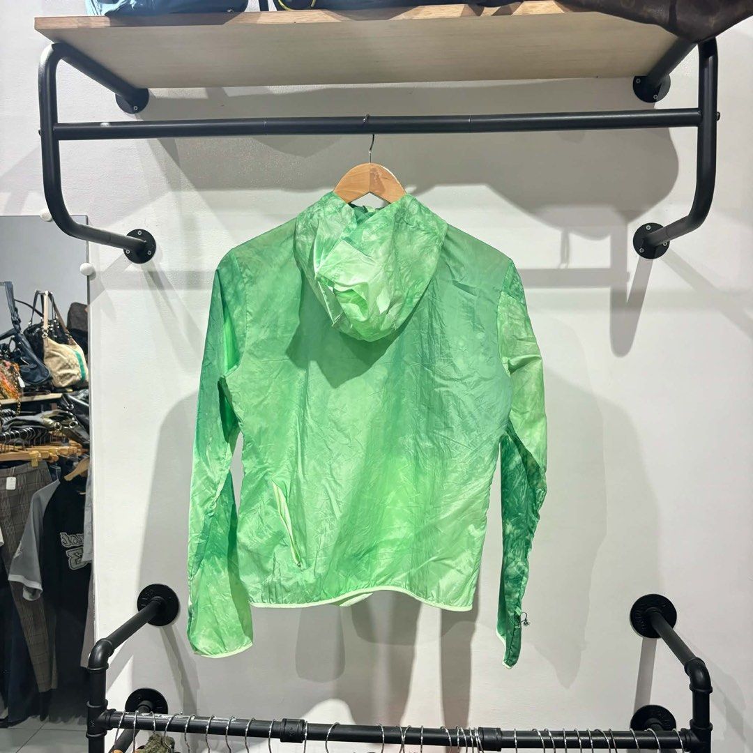 Nike Green Trail Running Windbreaker Jacket (Category: Coats, Jackets and Outerwear) located in Bambang. Submitted by heats777 (Listing ID 1467502367, Image 3). Description: - Brand: Nike Trail - Style: Green all-over tie-dye wash windbreaker jacket - Condition: Brand new with original tags attached, never worn - Features: Lightweight fabric, full zip front, attached hood with adjustable cinch cord, small chest logo, and a zipped pocket on the lo
