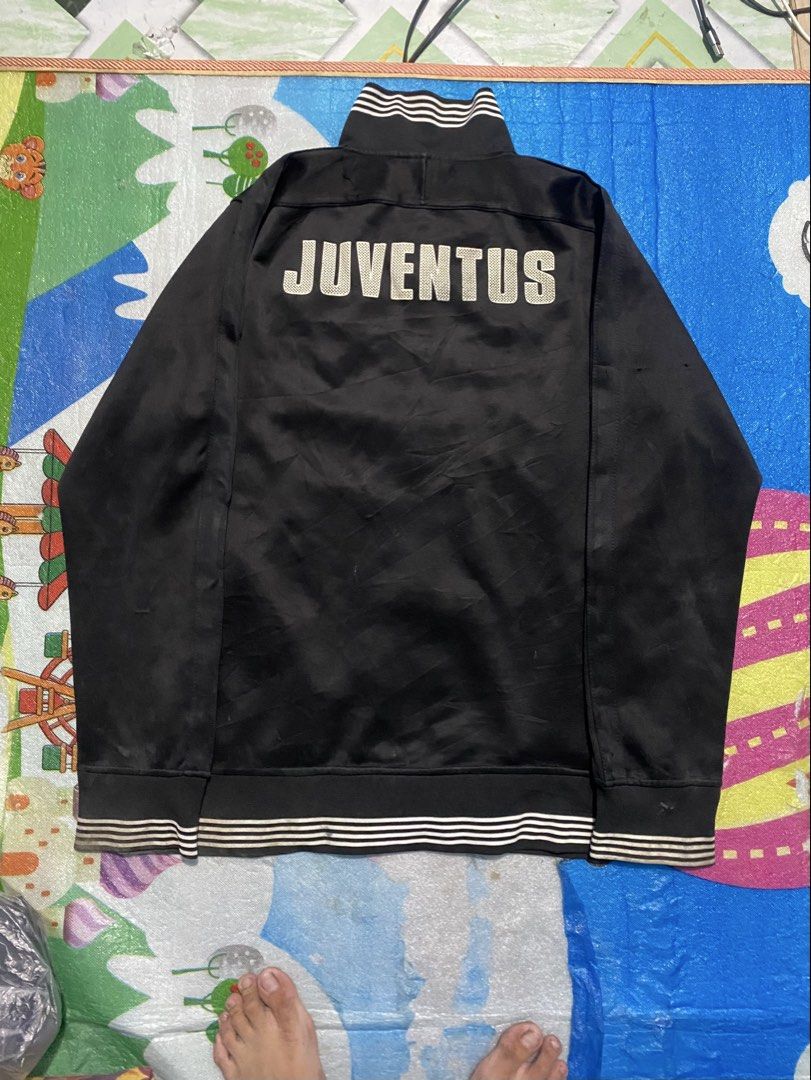Nike Juventus Black Track Jacket Size XL (Category: Coats, Jackets and Outerwear) located in Manila. Submitted by jerms.thriftah (Listing ID 1467461311, Image 2). Description: - Brand: Nike - Team: Juventus (Crest on chest, large lettering on back) - Color: Black - Size: XL (Made in Thailand) - Features: Full zip closure, stylish striped ribbed collar, cuffs, and hem - Condition: Shows some signs of wear and slight discoloration on the ribbed det