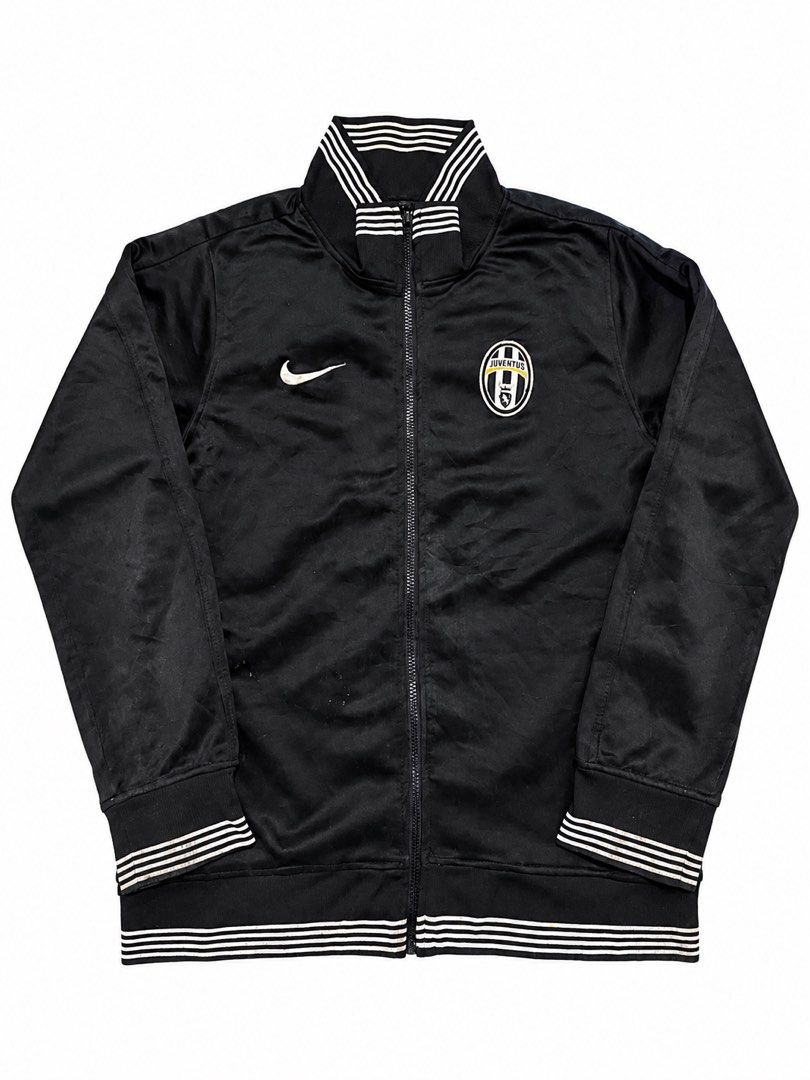 Nike Juventus Black Track Jacket Size XL (Category: Coats, Jackets and Outerwear) located in Manila. Submitted by jerms.thriftah (Listing ID 1467461311, Image 1). Description: - Brand: Nike - Team: Juventus (Crest on chest, large lettering on back) - Color: Black - Size: XL (Made in Thailand) - Features: Full zip closure, stylish striped ribbed collar, cuffs, and hem - Condition: Shows some signs of wear and slight discoloration on the ribbed det