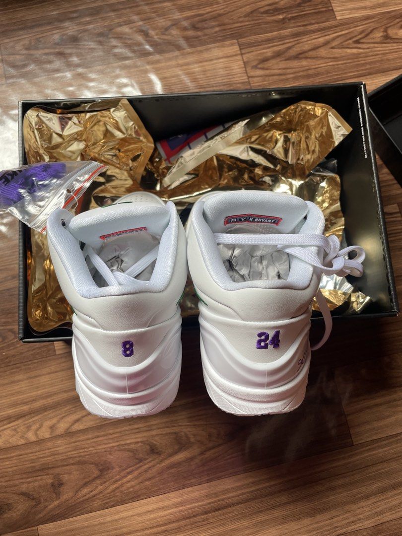 Nike Kobe IV Protro Draft Day US 9.5 (Category: Sneakers) located in San Pedro. Submitted by mharemilvalencia (Listing ID 1467535291, Image 3). Description: Nike Kobe IV Protro sneakers in the Draft Day colorway. White leather upper, green swoosh, purple accents on the heel and collar. Back heels embroidered with numbers 8 and 24. Includes original box, wrapping, and extra purple laces. Men size 9.5, women size 11. Clean outsoles, never worn..