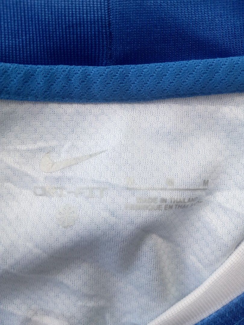 Nike Lions B5 Jersey Blue (Category: Activewear) located in Montevista. Submitted by johnboniel (Listing ID 1467392227, Image 3). Description: - Excellent Condition/like new - Dimes: 20x26 - Color rate; 9.5/10 - Brand: Nike - Team/Design: Blue with abstract geometric patterns, Lions crest, and white Swoosh - Customization: Back printed with 'LIONS' and number 'B5' in white block letters - Details: White V-neck collar, Nike engineered tag near bot