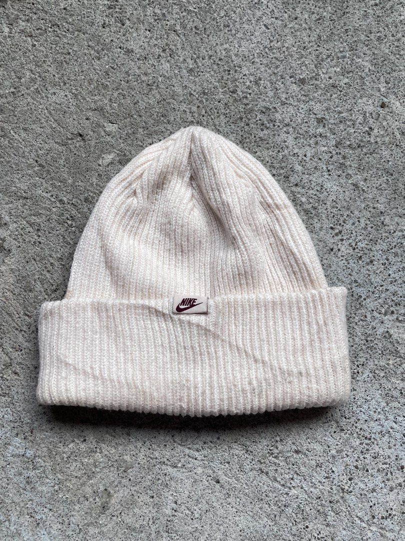 Nike Peak Beanie Off-White Ribbed Knit Hat (Category: Hats & Beanies) located in Siniloan. Submitted by rethr1ft (Listing ID 1467420362, Image 1). Description: - Brand: Nike - Style: Peak Beanie - Color: Off-white - Material: 100% polyester (body & lining) - Condition: Clean with tags attached inside - Size: One size fits most - Features: Ribbed knit with front Nike logo patch - Origin: Made in Vietnam.
