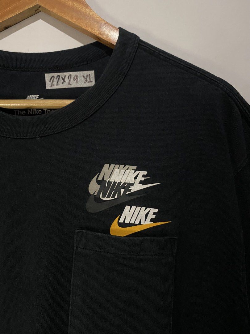 Nike Pocket T-Shirt Black Multiple Logos (Category: Tshirts & Polo Shirts ) located in Jaen. Submitted by oshimamark58418 (Listing ID 1467549620, Image 3). Description: - Brand: Nike - Color: Black - Size: Large - Pit to Pit: 22 inches - Length: 29 inches - Features: Layered chest logo graphics, single chest pocket, and special stitched branding tags near the hem - Origin: Made in China - Condition: Excellent pre-owned condition.