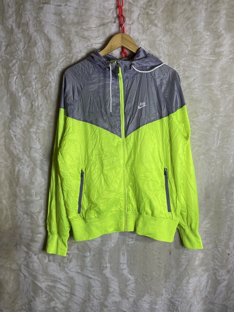 Nike Windrunner Jacket Grey Neon Yellow (Category: Coats, Jackets and Outerwear) located in Molave. Submitted by charlesthrifter (Listing ID 1467366489, Image 1). Description: - Authentic Nike Windrunner jacket in stylish grey and bright neon yellow - Full zip front with an adjustable drawstring hood - Two secure zippered hand pockets for your essentials - Breathable mesh lining and exclusive heritage story patch inside - Iconic Nike logo printed