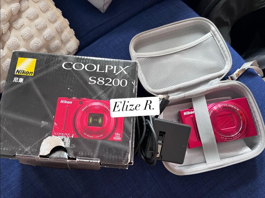Nikon Coolpix S8200 Red Digital Camera with Box (Category: Cameras) located in Imus. Submitted by elishenggg (Listing ID 1467422099, Image 3). Description: - Model: Nikon Coolpix point-and-shoot camera - Color: Bright red - Lens & Flash: 14x wide optical zoom lens with built-in pop-up flash - Condition: Great working condition, perfect for everyday use - Inclusions: Original box, carrying case, and charging cables included - Portability: Compact 