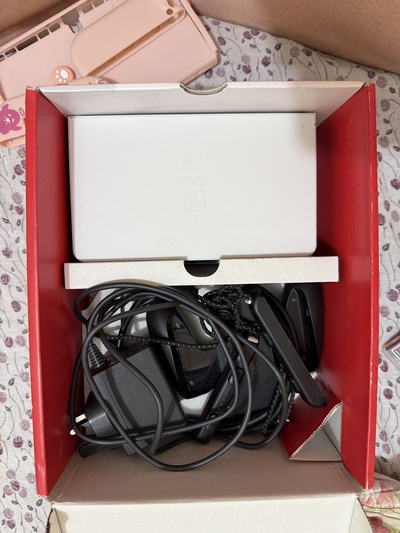 Nintendo Switch OLED Model White with Assassin's Creed (Category: Nintendo) located in Quezon City. Submitted by nclriveraaa (Listing ID 1467564742, Image 2). Description: - Item: Nintendo Switch OLED Model (White) - Condition: 9/10, packed in original box. Working and barely used since I’m in Medical School t__t - Included Hardware: Console, White Joy-Cons, Dock, Power Adapter, Joy-Con Straps - Freebies & Extras: Pink protective case, thumb grip