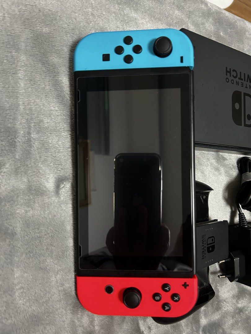 Nintendo Switch V1 Console with Dock, Joy-Cons, and Case (Category: Nintendo) located in Malolos. Submitted by z.shops (Listing ID 1467515448, Image 3). Description: - Nintendo Switch Console with Neon Blue & Red Joy-Cons - Includes TV dock, power adapter, and Joy-Con grip - Bonus: Patterned carrying case included - Screen and console are 100% working and tested - Minor, standard wear on the dock and grip from normal use - Perfect for both handhe
