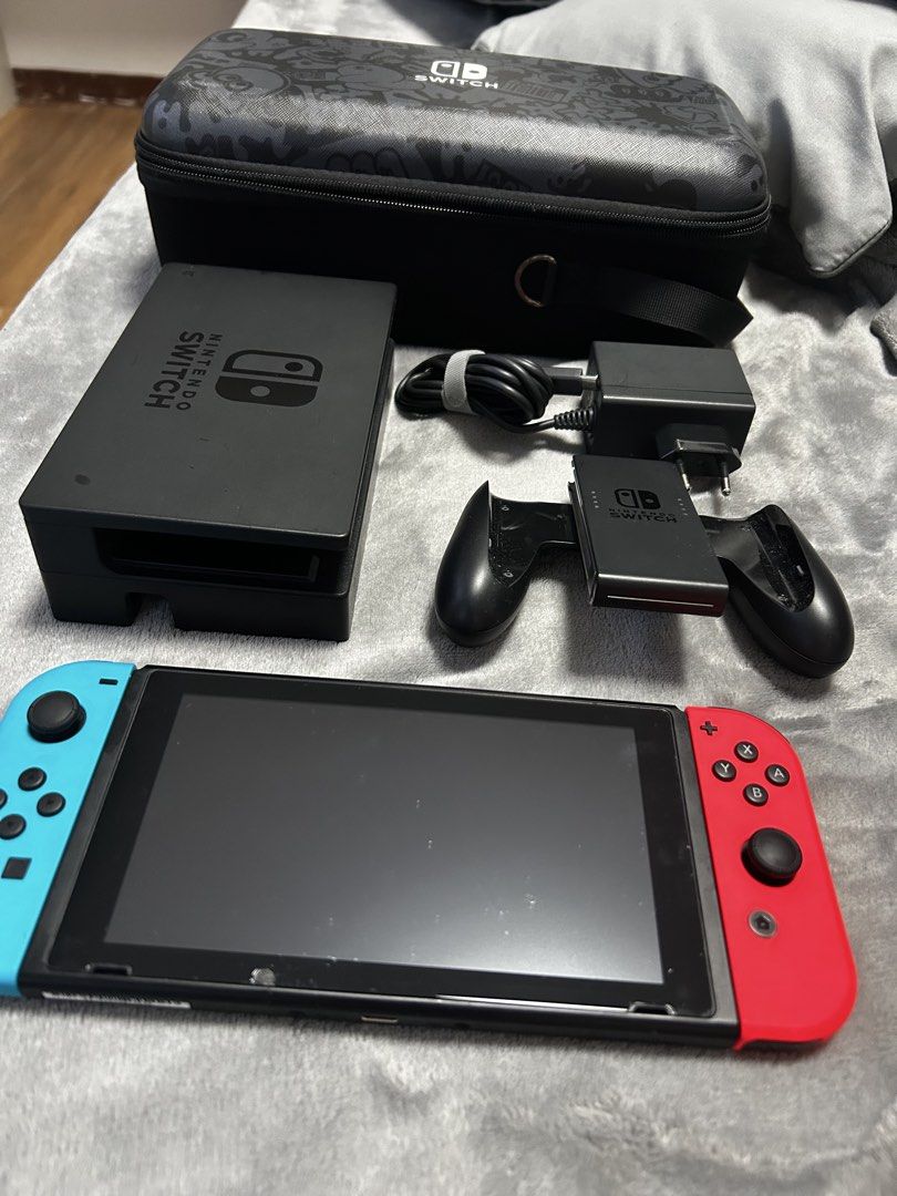 Nintendo Switch V1 Console with Dock, Joy-Cons, and Case (Category: Nintendo) located in Malolos. Submitted by z.shops (Listing ID 1467515448, Image 1). Description: - Nintendo Switch Console with Neon Blue & Red Joy-Cons - Includes TV dock, power adapter, and Joy-Con grip - Bonus: Patterned carrying case included - Screen and console are 100% working and tested - Minor, standard wear on the dock and grip from normal use - Perfect for both handhe