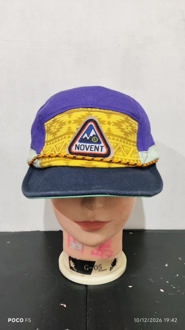 Novent Multicolored 5-Panel Camping Hat Cap (Category: Caps & Hats) located in Quezon City. Submitted by ralphralph (Listing ID 1467498860, Image 1). Description: - Brand/Style: Unique multi-panel camper cap from Novent - Design: Vibrant purple crown, yellow geometric front panel, and teal polka dot brim trim - Details: Features a cool mountain graphic patch on the front and metal ventilation eyelets - Fit: Adjustable strapback closure at the rea