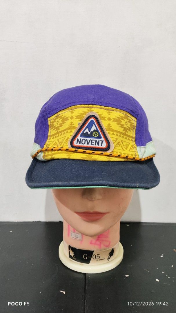 Novent Multicolored 5-Panel Camping Hat Cap (Category: Caps & Hats) located in Quezon City. Submitted by ralphralph (Listing ID 1467498860, Image 2). Description: - Brand/Style: Unique multi-panel camper cap from Novent - Design: Vibrant purple crown, yellow geometric front panel, and teal polka dot brim trim - Details: Features a cool mountain graphic patch on the front and metal ventilation eyelets - Fit: Adjustable strapback closure at the rea