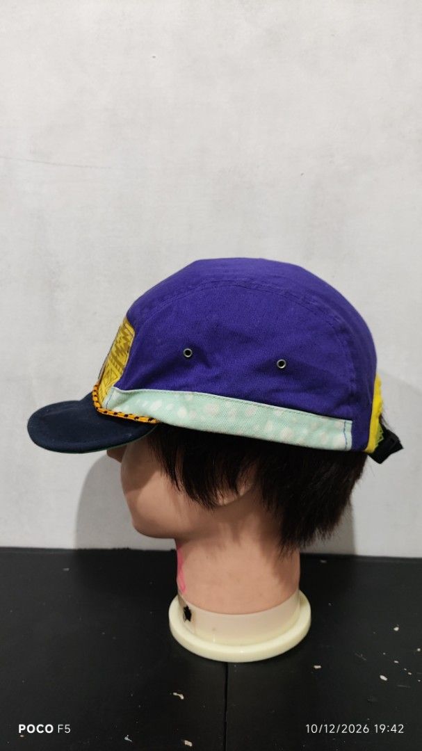Novent Multicolored 5-Panel Camping Hat Cap (Category: Caps & Hats) located in Quezon City. Submitted by ralphralph (Listing ID 1467498860, Image 3). Description: - Brand/Style: Unique multi-panel camper cap from Novent - Design: Vibrant purple crown, yellow geometric front panel, and teal polka dot brim trim - Details: Features a cool mountain graphic patch on the front and metal ventilation eyelets - Fit: Adjustable strapback closure at the rea