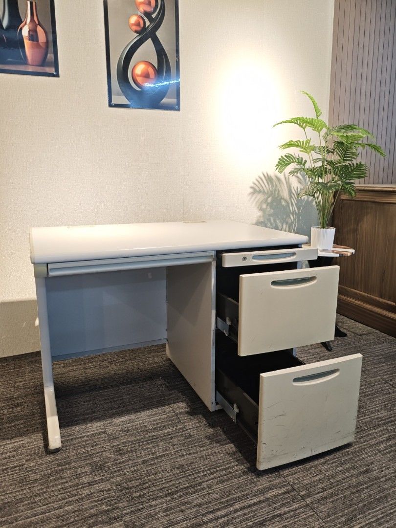 Office Busters Office Desk with Drawers (Category: Office Furniture & Fixtures) located in Quezon City. Submitted by kevinmacabata12997160 (Listing ID 1467365933, Image 2). Description: - Brand: Office Busters - Color/Finish: Light grey top with sturdy metal frame - Storage: Attached multi-drawer cabinet on the right side with built-in lock - Features: Spacious surface for monitors, keyboards, and paperwork - Style: Clean, modern design ideal for