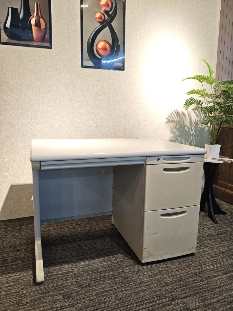 Office Busters Office Desk with Drawers (Category: Office Furniture & Fixtures) located in Quezon City. Submitted by kevinmacabata12997160 (Listing ID 1467365933, Image 3). Description: - Brand: Office Busters - Color/Finish: Light grey top with sturdy metal frame - Storage: Attached multi-drawer cabinet on the right side with built-in lock - Features: Spacious surface for monitors, keyboards, and paperwork - Style: Clean, modern design ideal for