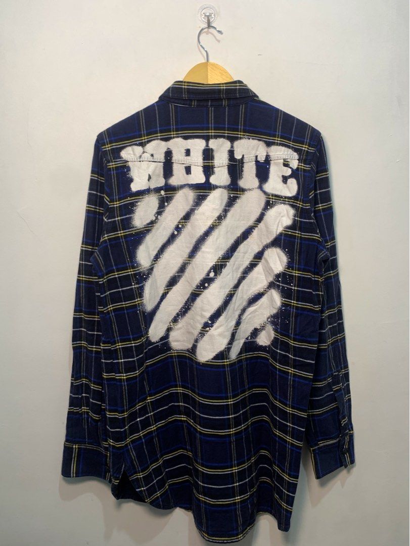 Off-White Blue Plaid Flannel Shirt (Category: Tshirts & Polo Shirts ) located in Davao. Submitted by legitseller1111 (Listing ID 1467468932, Image 2). Description: - Brand: Off-White c/o Virgil abloh -Size Xl tall mens! - Design: Navy blue, yellow, and white plaid flannel with white paint splatter details near the hem - Back Details: Iconic white diagonal stripes print with 'WHITE' text across the shoulders - Features: Dual chest flap pockets, bu