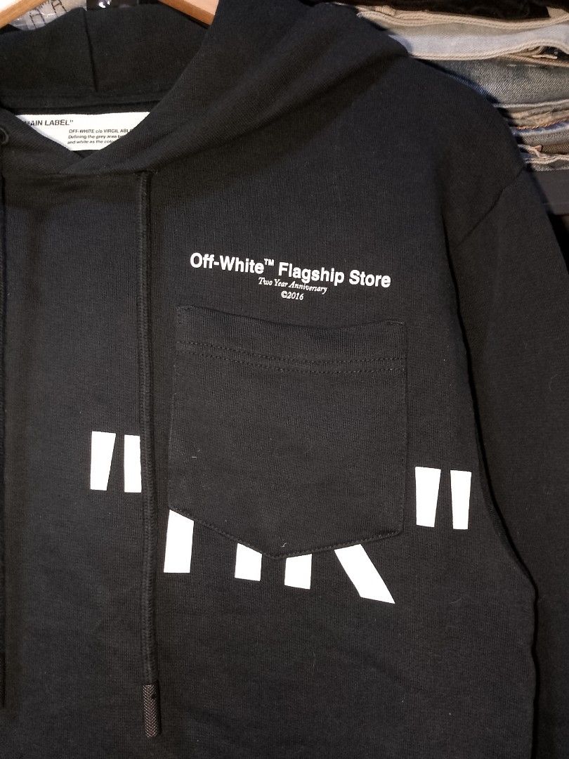 Off-White Flagship Store Two Year Anniversary Hoodie (Category: Coats, Jackets and Outerwear) located in Manila. Submitted by mjthrifted_second (Listing ID 1467421001, Image 3). Description: - Brand: Off-White - Collection: Flagship Store Two Year Anniversary - Color: Black - Size: Small -Dimes: 20/29 - Material: 100% cotton - Design: Front chest pocket with white graphic text and signature diagonal square prints - Features: Adjustable drawstring
