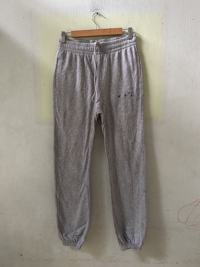 Off-White Grey Sweatpants with Diagonal Arrows (Category: Joggers) located in Pandi. Submitted by nasya_thrift_collection2023 (Listing ID 1467415253, Image 1). Description: - Brand: Off-White - Color: Grey - Material: Comfortable fleece - Fit/Style: Drawstring waist and cuffed ankles - Details: Small black front logo, signature white diagonal outlines on the back, and a single back pocket with button closure - Condition: Interior tags show some w