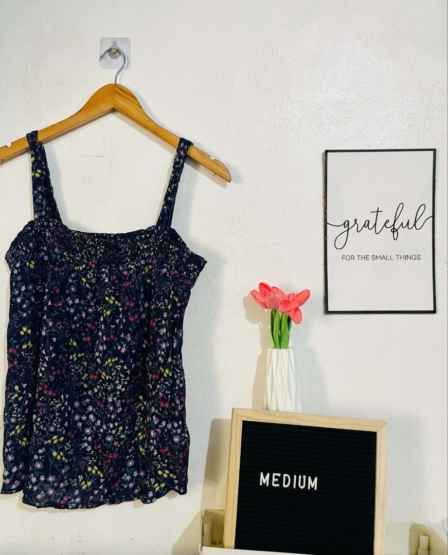 Old Navy Floral Cami Tank Top Medium (Category: Sleeveless) located in San Mateo. Submitted by safeearth21 (Listing ID 1467589510, Image 1). Description: - Brand: Old Navy - Size: M - Color: Dark blue with colorful small floral print - Design: Square neckline, wide straps, and smocked elastic bodice - Material: Lightweight fabric - Origin: Made in India - Condition: Brand new with tag attached.