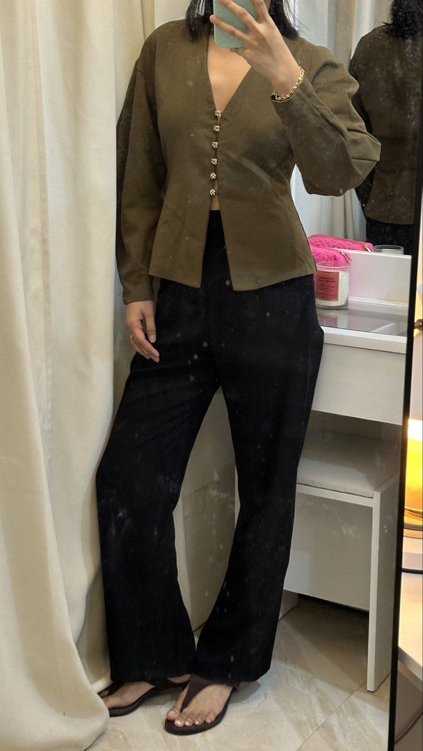 Olive Green Button-Up V-Neck Long Sleeve Blouse (Category: Longsleeves) located in Rizal. Submitted by literally.lori (Listing ID 1467436675, Image 2). Description: - Color: Olive green - Neckline: V-neck - Sleeves: Thick Long sleeves with slightly puffed shoulders - Details: Gold-toned decorative front buttons - Fit: Structured waist for a flattering silhouette - Styling: Easily pairs with black trousers or jeans for casual or dressed-up looks.