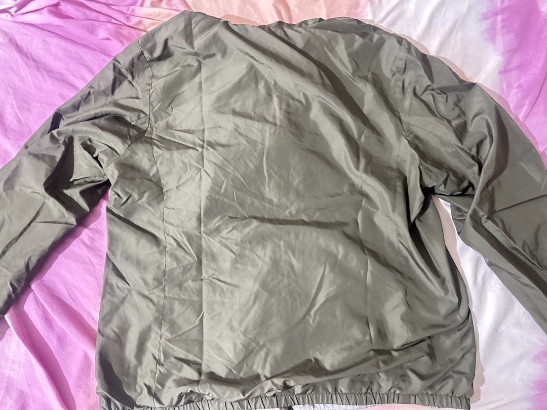 Olive green Uniqlo Windbreaker (Category: Coats, Jackets and Outerwear) located in Manila. Submitted by barntobeep (Listing ID 1467557553, Image 2). Description: - Color: Solid olive green - Size XL - Mode of Delivery: Grab Express, Lalamove, LBC - Mode of Payment: GCash, Maya, Maribank Shipping will be shouldered by buyer .