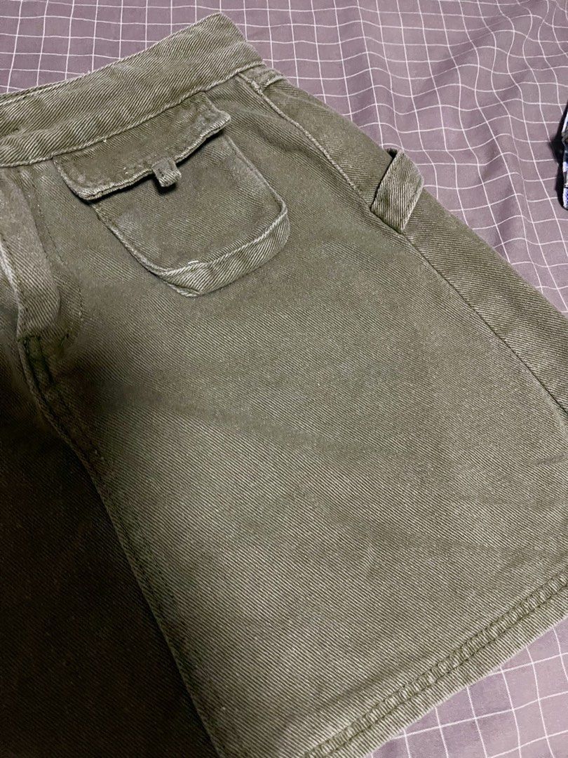 Olive green utility mini skirt with cargo pockets size 27” to 28” (Category: Skirts) located in Calamba. Submitted by goldenprngs101 (Listing ID 1467470621, Image 2). Description: - Color: Olive green - Material: Sturdy cotton twill with great structure - Style: Cargo mini skirt with side loop detail - Closures & Pockets: Front button/zip closure and dual front hip flap pockets - Styling: Perfect to pair with basic tees and tanks for casual outin