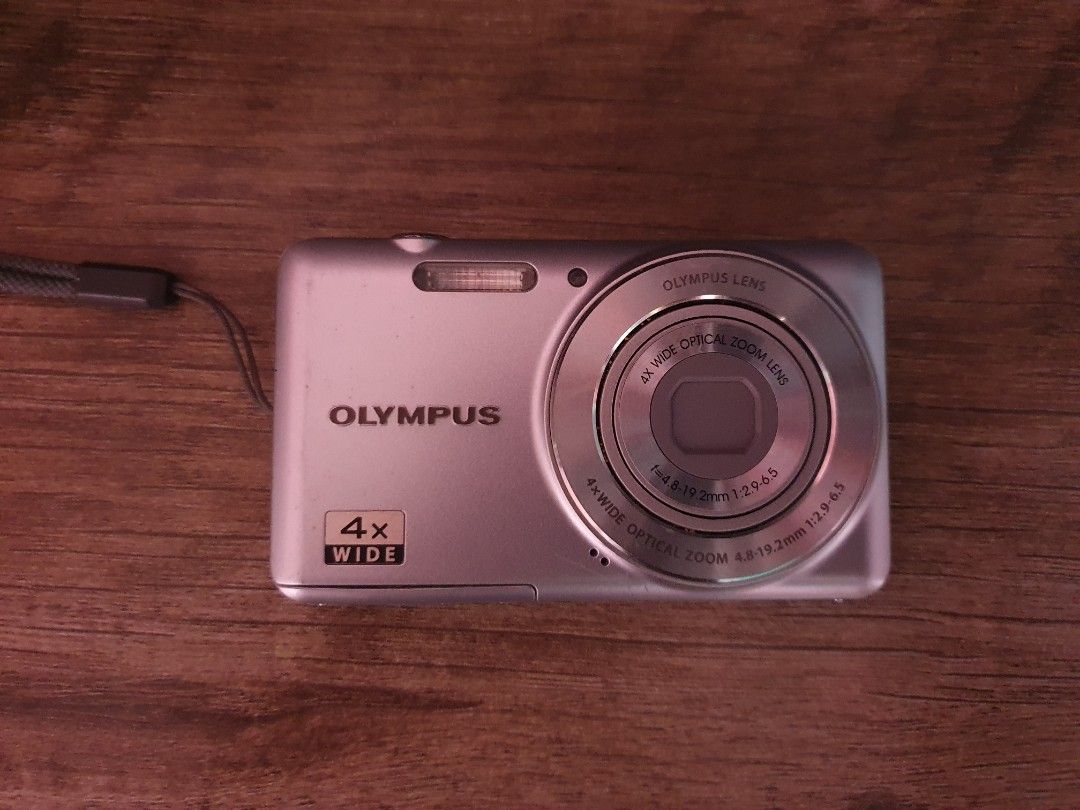 Olympus VG-150 12 Megapixel Digital Camera (Category: Cameras) located in Manila. Submitted by paustria1813723 (Listing ID 1467537309, Image 1). Description: - Sleek silver pocket digital camera - 12 megapixels with 4x wide optical zoom lens - Standard rear LCD screen with easy right-side navigation buttons - Uses SDHC memory cards - Bottom tripod mount and secure battery door - Cosmetic condition: Minor paint wear near the model text on the top 