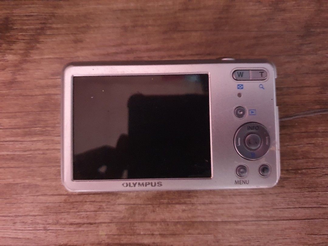 Olympus VG-150 12 Megapixel Digital Camera (Category: Cameras) located in Manila. Submitted by paustria1813723 (Listing ID 1467537309, Image 2). Description: - Sleek silver pocket digital camera - 12 megapixels with 4x wide optical zoom lens - Standard rear LCD screen with easy right-side navigation buttons - Uses SDHC memory cards - Bottom tripod mount and secure battery door - Cosmetic condition: Minor paint wear near the model text on the top 