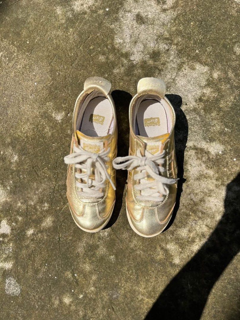 Onitsuka Tiger Metallic Gold Sneakers (Category: Sneakers) located in Molave. Submitted by mattjalamanadoromal323 (Listing ID 1467522818, Image 2). Description: - Brand: Onitsuka Tiger - Color: Metallic gold with light beige laces and heel tab - Design: Classic low-top statement sneakers - Sole: Textured rubber outsole with great grip - Condition: Minor creasing on the metallic finish from normal wear; insoles are clean with branded tags intact.