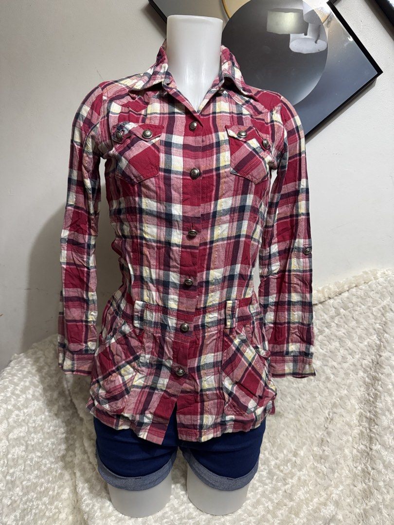ONLY Red Plaid Button-Up Tunic Shirt Size 160/80A (Category: Blouses) located in Marikina City. Submitted by lorradel (Listing ID 1467504518, Image 1). Description: - fits XS-S - Brand: ONLY - Style: Red plaid tunic shirt with long sleeves - Size: 160/80A - Details: Button-front closure, two chest pockets, and two waist pockets with button flaps - Feature: Eye-catching metallic silver lettering graphic across the back shoulders - Material: Lightw
