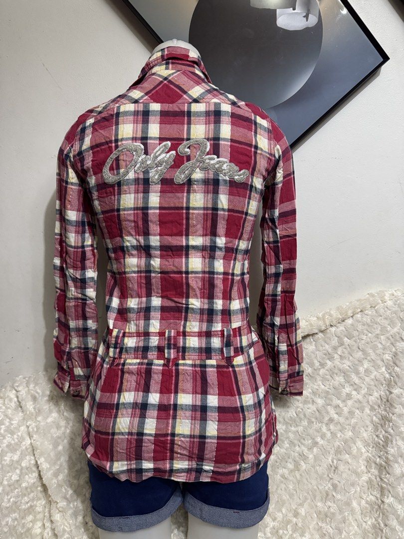ONLY Red Plaid Button-Up Tunic Shirt Size 160/80A (Category: Blouses) located in Marikina City. Submitted by lorradel (Listing ID 1467504518, Image 3). Description: - fits XS-S - Brand: ONLY - Style: Red plaid tunic shirt with long sleeves - Size: 160/80A - Details: Button-front closure, two chest pockets, and two waist pockets with button flaps - Feature: Eye-catching metallic silver lettering graphic across the back shoulders - Material: Lightw