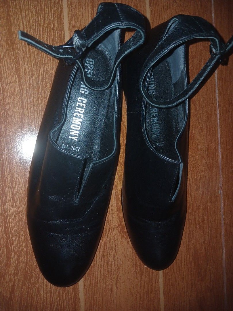 Opening Ceremony Black Leather Ankle Strap Flats (Category: Flats & Sandals) located in Marikina City. Submitted by laila15 (Listing ID 1467422567, Image 2). Description: - Brand: Opening Ceremony - Style: Black leather flats with ankle strap buckle closure - Design: Closed round toe with a stylish v-cut slit at the vamp - Material: Smooth leather upper and comfortable inner lining - Heel: Sturdy low heel block for all-day comfort - Condition: So