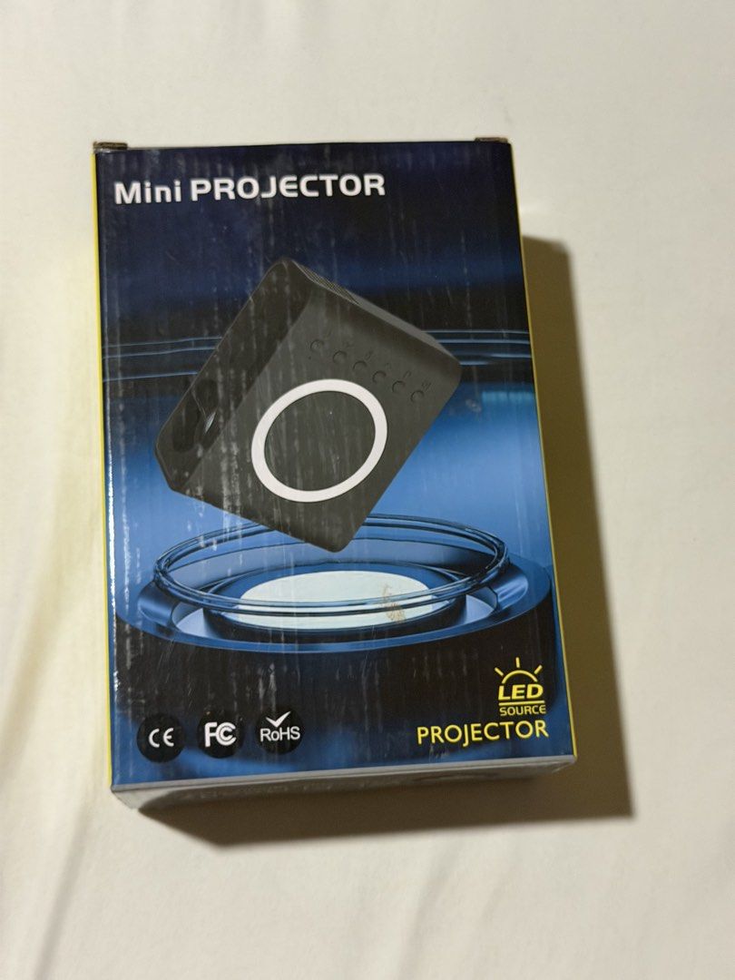 Optimus Mini Wi-Fi LED Projector (Category: Projectors) located in Pasig City. Submitted by sephieysabelle (Listing ID 1467434467, Image 1). Description: - Color: Sleek Black - Connectivity: Wi-Fi enabled for easy streaming - Resolution: Native 320x240, supports up to 1920x1080 max - Projection: 0.5 to 4 meters distance with 16 to 100 inches image size - Dimensions & Weight: Compact size at 110x90x50mm and lightweight at 250g - Inclusions: Power 