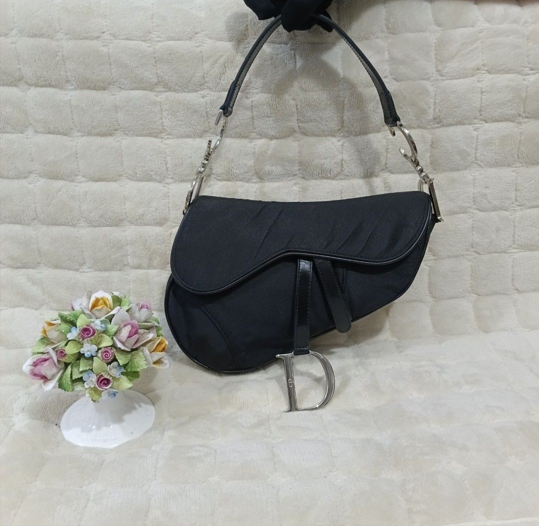 ORIGINAL CHRISTIAN DIOR BLACK NYLON SADDLE BAG (Category: Luxury Bags & Wallets) located in Manila. Submitted by fabluxury.corner (Listing ID 1467554866, Image 1). Description: Guaranteed original ✅ Rank A very good condition No functionality issue / no major flaws Professionally recolor on bag spa / no lagkit or sticky feel / not hard in texture/ looks nothing happen / so pretty in actual.